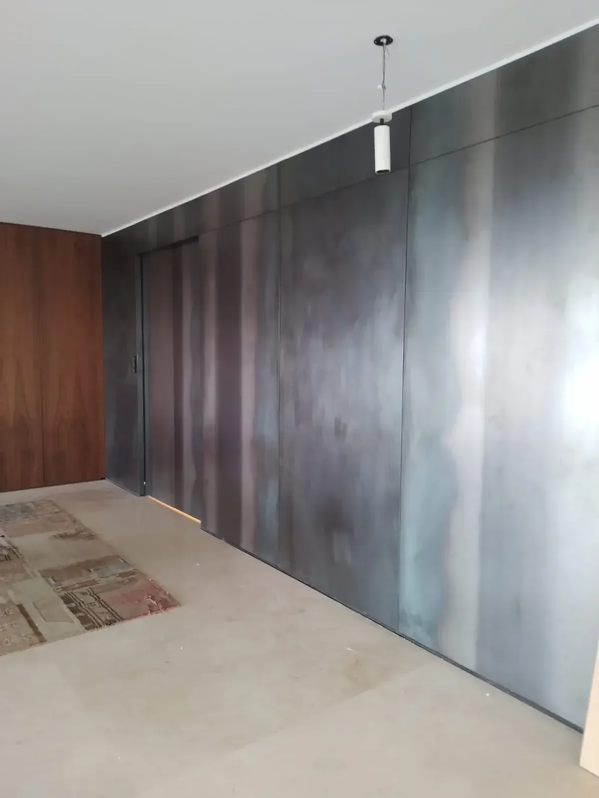 Revestimiento y puerta metálica de líneas modernas integrados al interior